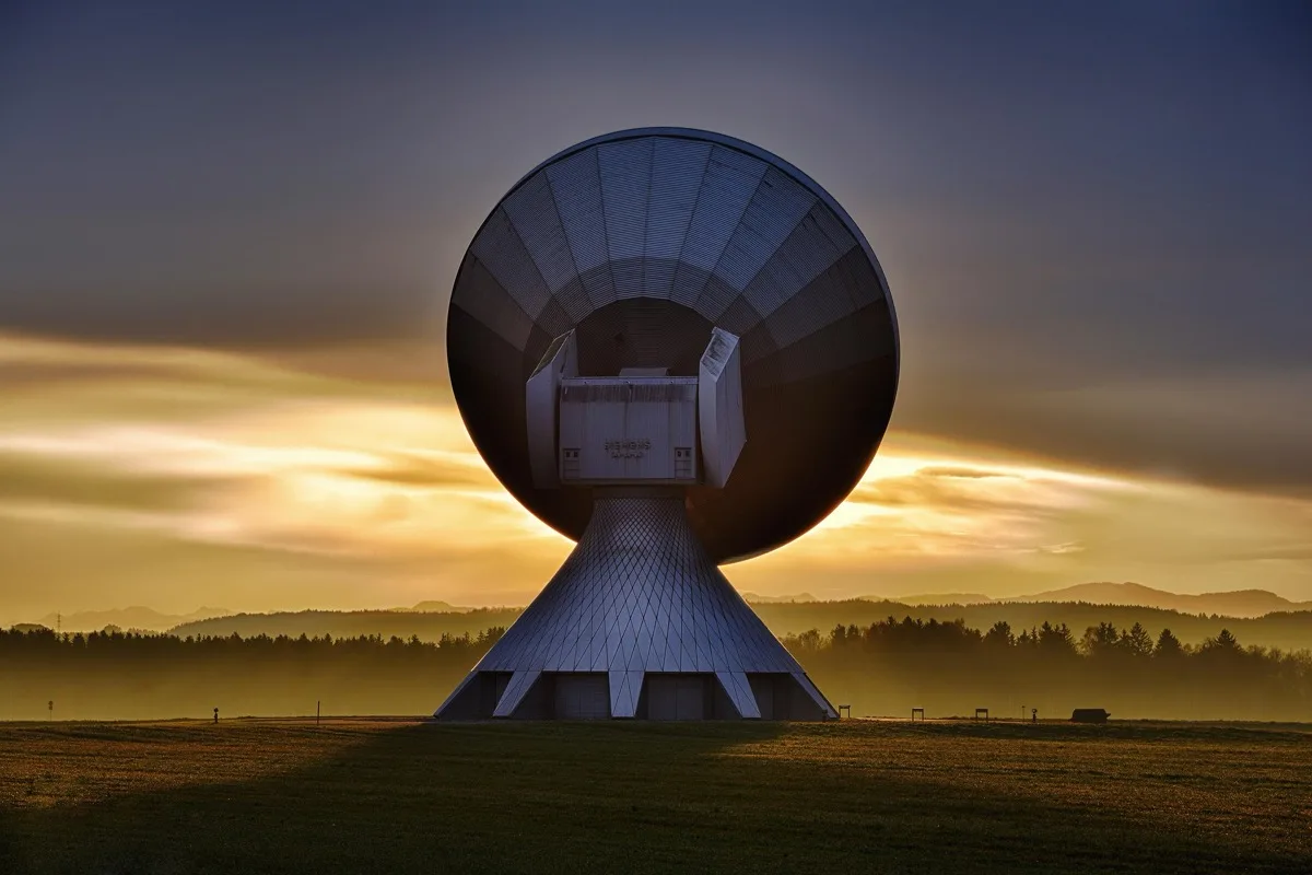 Satellite ground-station dish at golden hour
